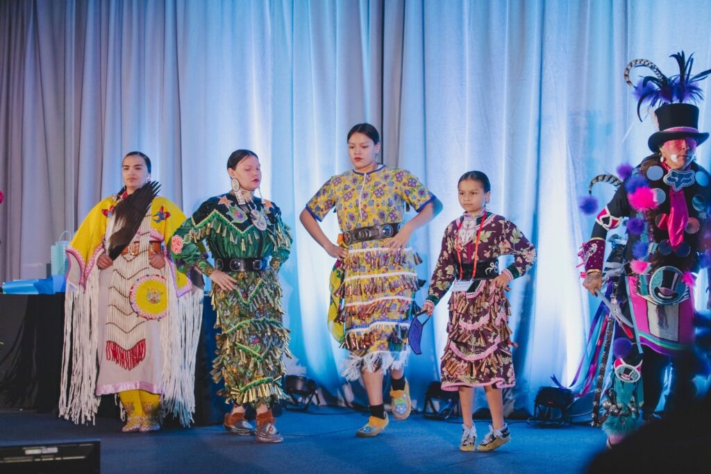 Native American dancers on a stage.