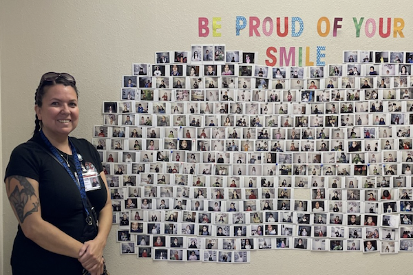 Nurse standing in front of pictures of patients
