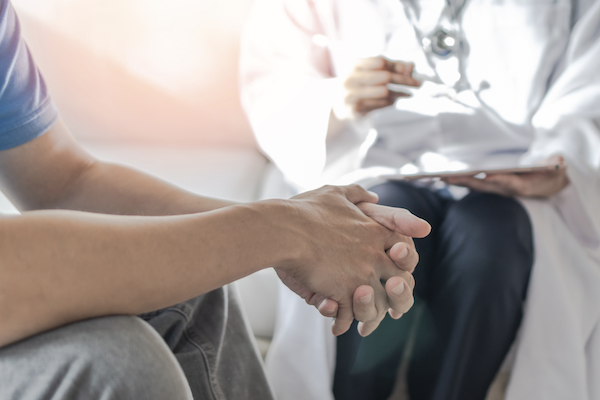 Doctor sitting with patient